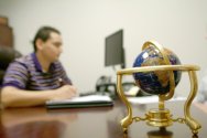 Employee at Desk With Globe