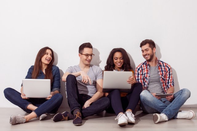 group of people sitting on the ground collaborating