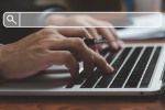 Person typing on laptop keyboard