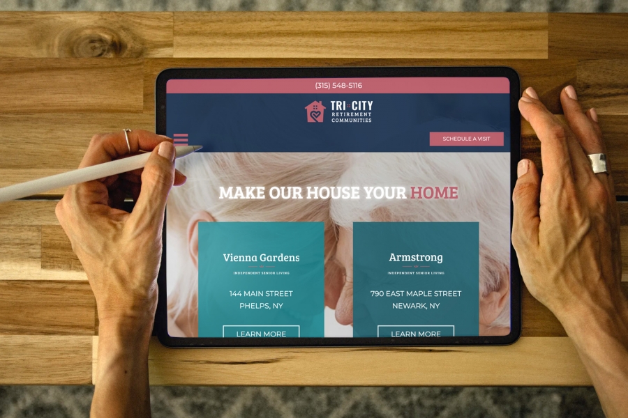 Woman holding tablet with Tri-City home page